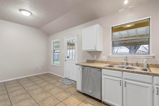 kitchen featuring vaulted ceiling, white cabinetry, sink, stainless steel dishwasher, and a textured ceiling