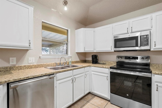 kitchen with sink, white cabinets, and appliances with stainless steel finishes