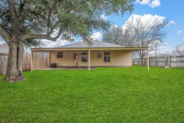 rear view of property featuring a patio and a lawn