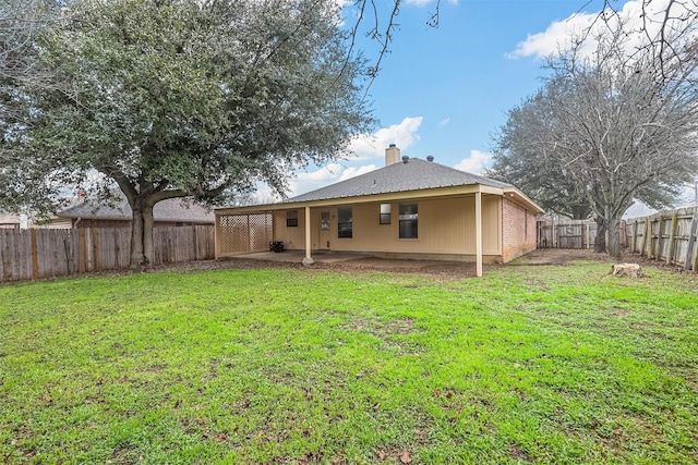 back of property featuring a lawn