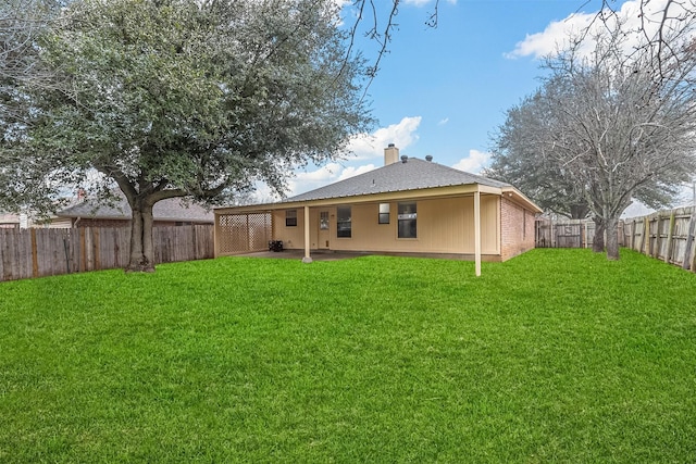 back of house with a lawn