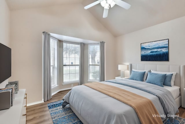 bedroom featuring hardwood / wood-style flooring, ceiling fan, and high vaulted ceiling