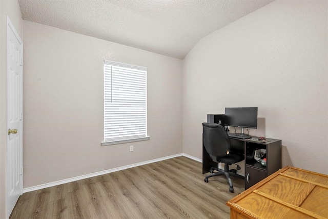 office space featuring hardwood / wood-style flooring, lofted ceiling, and a textured ceiling