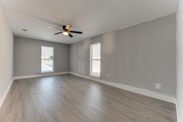 spare room with light hardwood / wood-style floors and ceiling fan