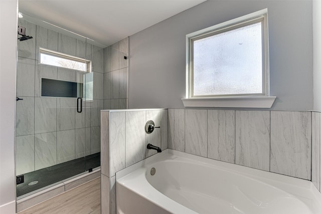 bathroom featuring separate shower and tub