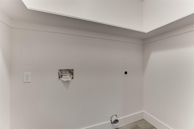 washroom featuring hardwood / wood-style flooring and electric dryer hookup