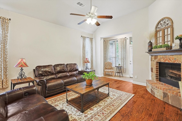 living room with ceiling fan, lofted ceiling, and wood-type flooring