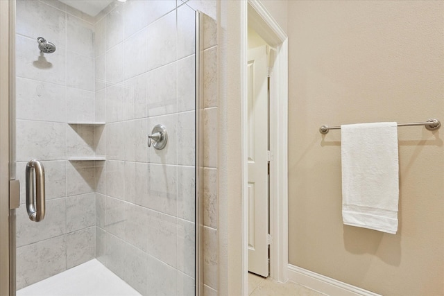 bathroom with a shower with door