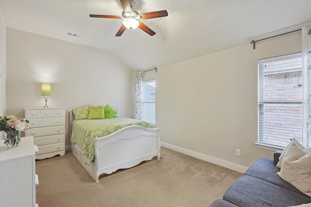 bedroom with ceiling fan, light colored carpet, and vaulted ceiling