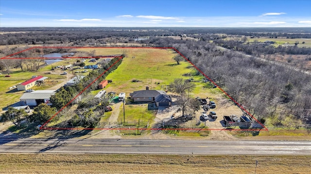 birds eye view of property featuring a water view and a rural view