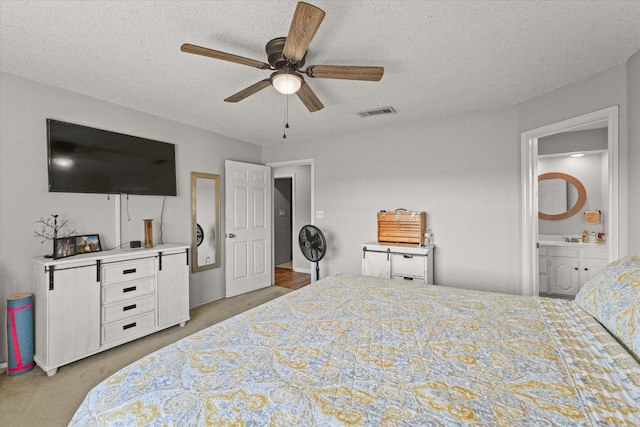 bedroom with a textured ceiling, ceiling fan, and light colored carpet