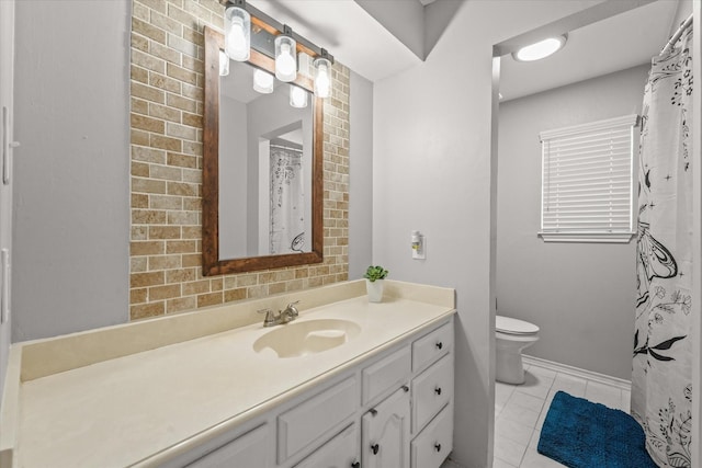 bathroom with vanity, tile patterned flooring, and toilet