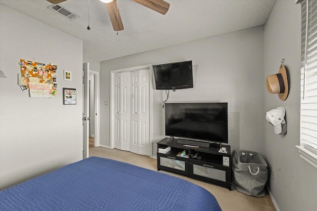 bedroom with light carpet, a closet, and ceiling fan