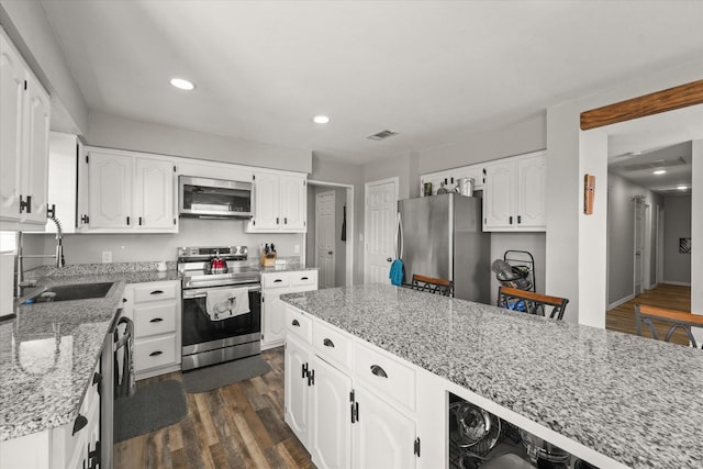 kitchen featuring stainless steel appliances, light stone countertops, white cabinets, sink, and dark hardwood / wood-style floors