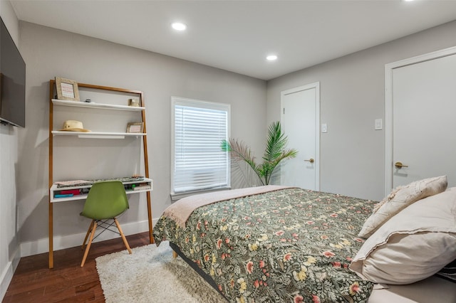 bedroom with dark hardwood / wood-style floors