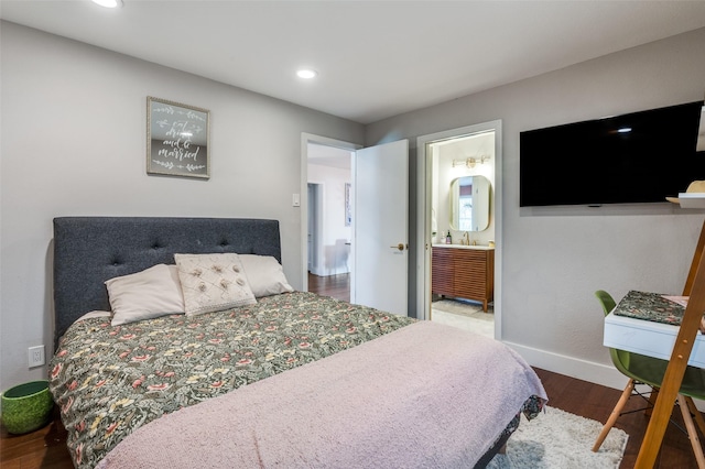 bedroom featuring connected bathroom and hardwood / wood-style floors