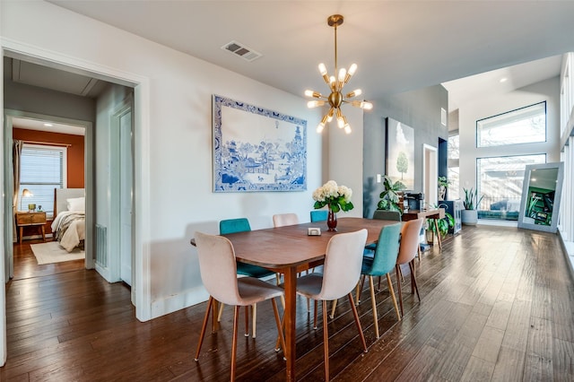 dining area with an inviting chandelier, a wealth of natural light, and dark wood-type flooring