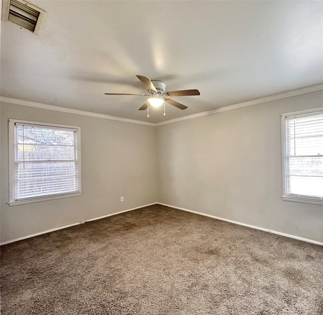 spare room featuring crown molding, carpet floors, and ceiling fan