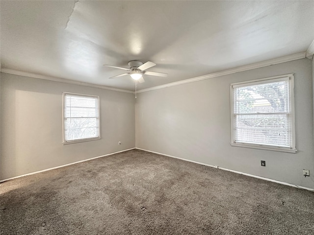 empty room featuring crown molding, ceiling fan, and carpet flooring