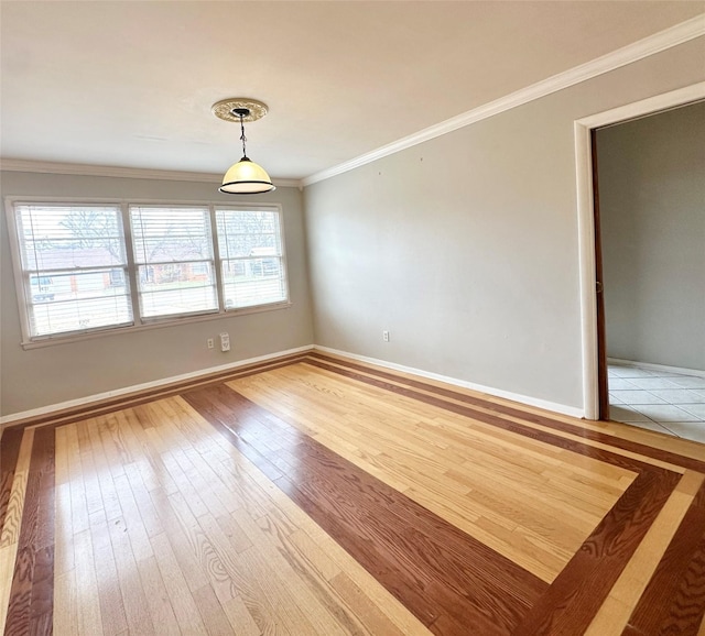 spare room with hardwood / wood-style flooring and crown molding