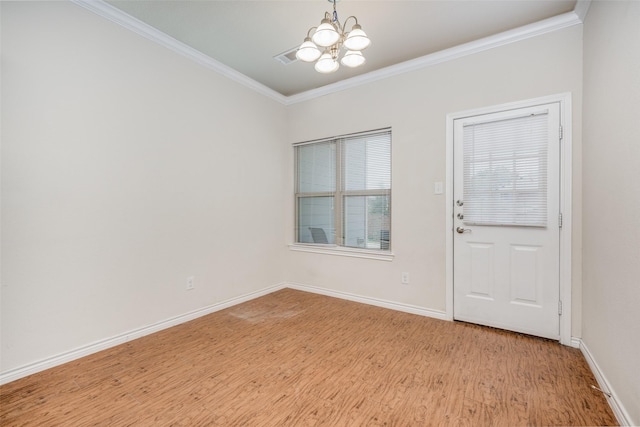 entrance foyer featuring ornamental molding, a chandelier, and light hardwood / wood-style floors