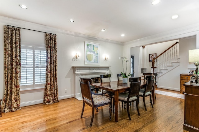 dining area featuring light hardwood / wood-style flooring and ornamental molding