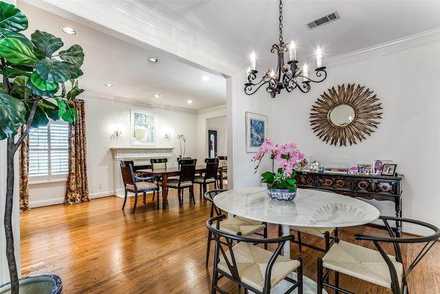 dining space with crown molding and hardwood / wood-style flooring