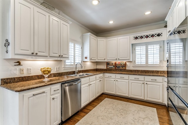 kitchen featuring white cabinetry, sink, dark stone countertops, stainless steel dishwasher, and dark wood-type flooring