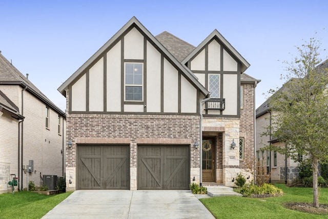 english style home featuring brick siding, central AC unit, stucco siding, and concrete driveway