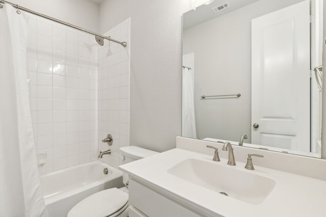 full bathroom with visible vents, vanity, toilet, and shower / bath combo with shower curtain