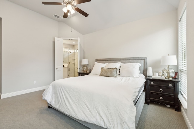 bedroom with baseboards, visible vents, ensuite bath, lofted ceiling, and light carpet