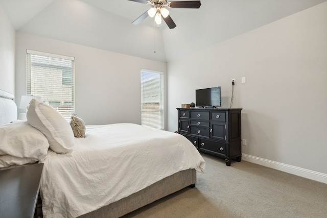 bedroom featuring baseboards, multiple windows, lofted ceiling, and light carpet