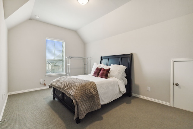 bedroom featuring baseboards, carpet floors, and vaulted ceiling