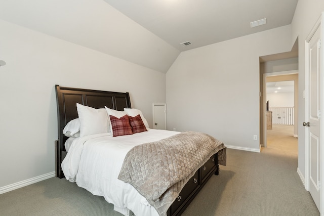 carpeted bedroom featuring visible vents, baseboards, and vaulted ceiling