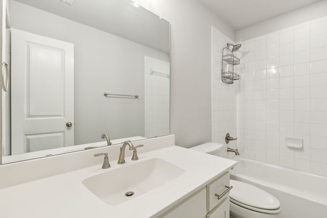 bathroom with vanity, shower / bathing tub combination, and toilet