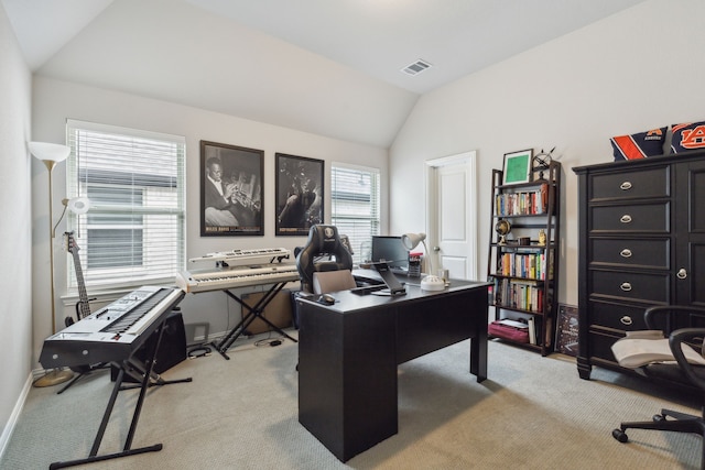 office featuring visible vents, lofted ceiling, light colored carpet, and baseboards