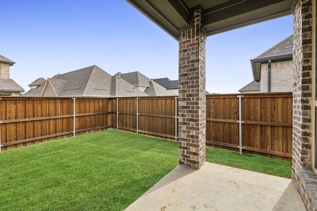 view of yard featuring a patio area and a fenced backyard