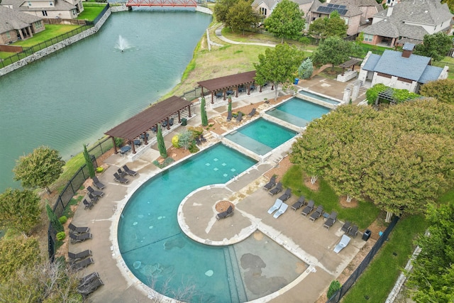 drone / aerial view featuring a residential view and a water view