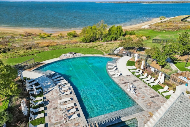 birds eye view of property featuring a beach view and a water view