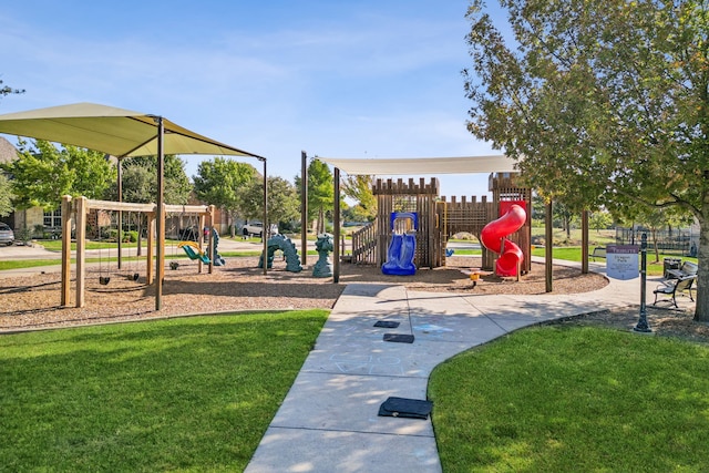 communal playground featuring a lawn