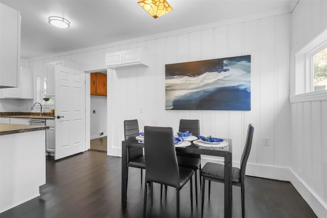 dining space featuring ornamental molding and dark hardwood / wood-style flooring