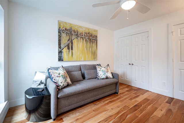 living room with hardwood / wood-style flooring and ceiling fan