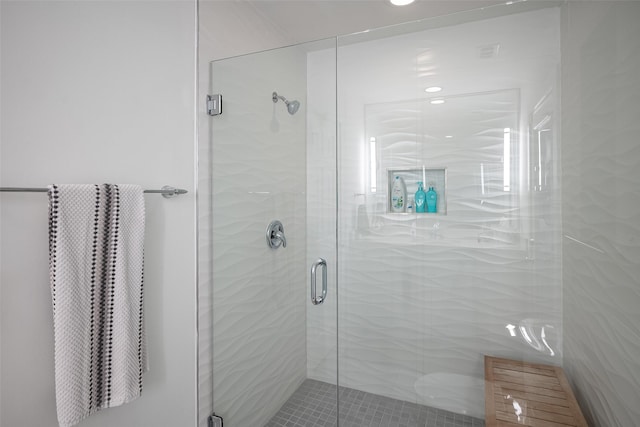 bathroom with a shower with door