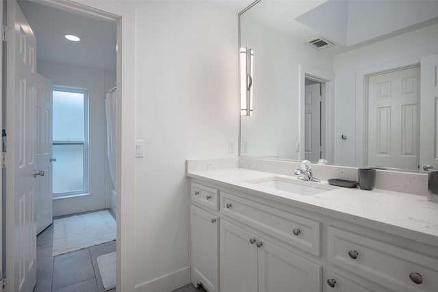 bathroom featuring tile patterned flooring, vanity, and shower / bathtub combination with curtain