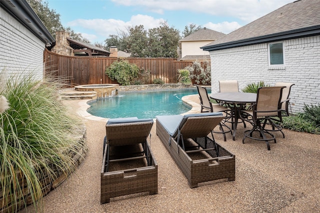 view of swimming pool with an in ground hot tub and a patio area