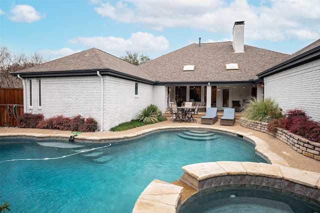 view of pool with an in ground hot tub and a patio area