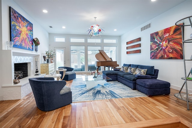 living room with hardwood / wood-style flooring and a fireplace