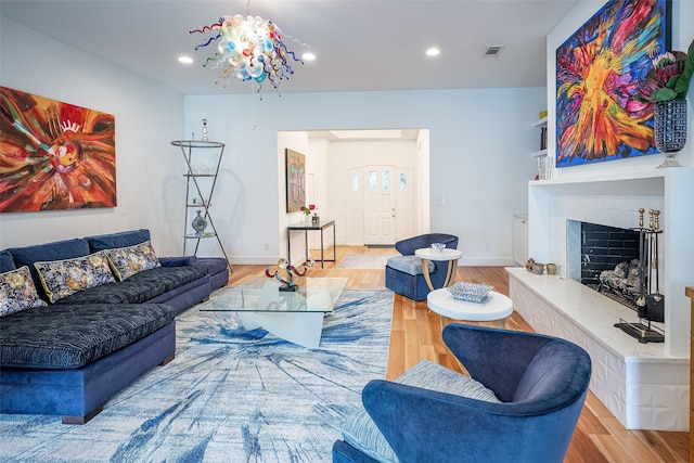 living room with a notable chandelier and light wood-type flooring