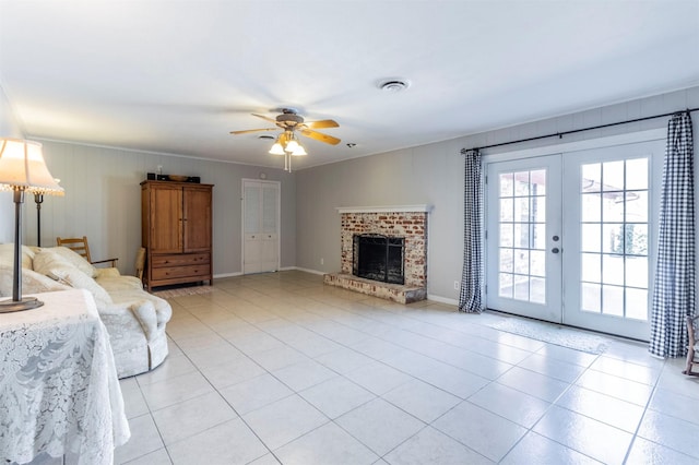 unfurnished living room featuring a fireplace, french doors, ceiling fan, and light tile patterned flooring