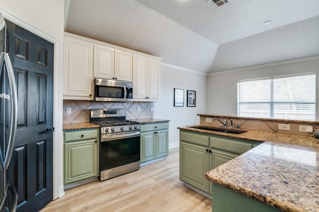 kitchen featuring stainless steel appliances, green cabinets, and white cabinets